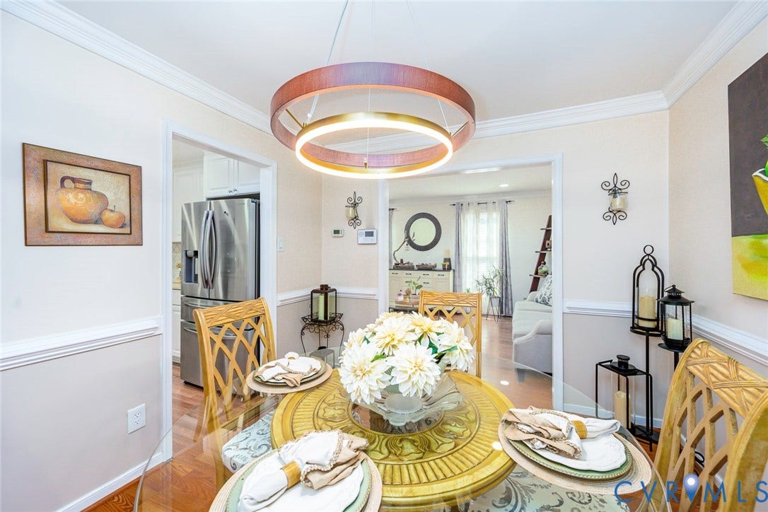 Recessed overhead lighting, crown molding, chair rail, wood-finish flooring, and open doorways