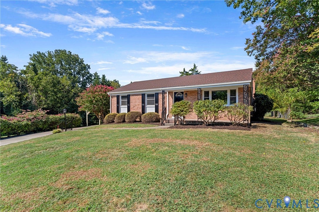 7402 Edgewood Avenue, Richmond, VA 23227 Brick exterior with a gabled roof and dark shingle roofing