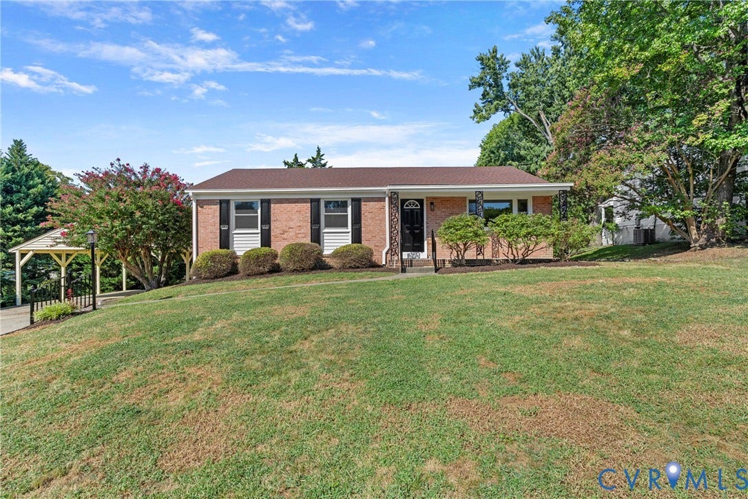 7402 Edgewood Avenue, Richmond, VA 23227 Brick exterior with dark shutters, covered front entry, and established foundation plantings