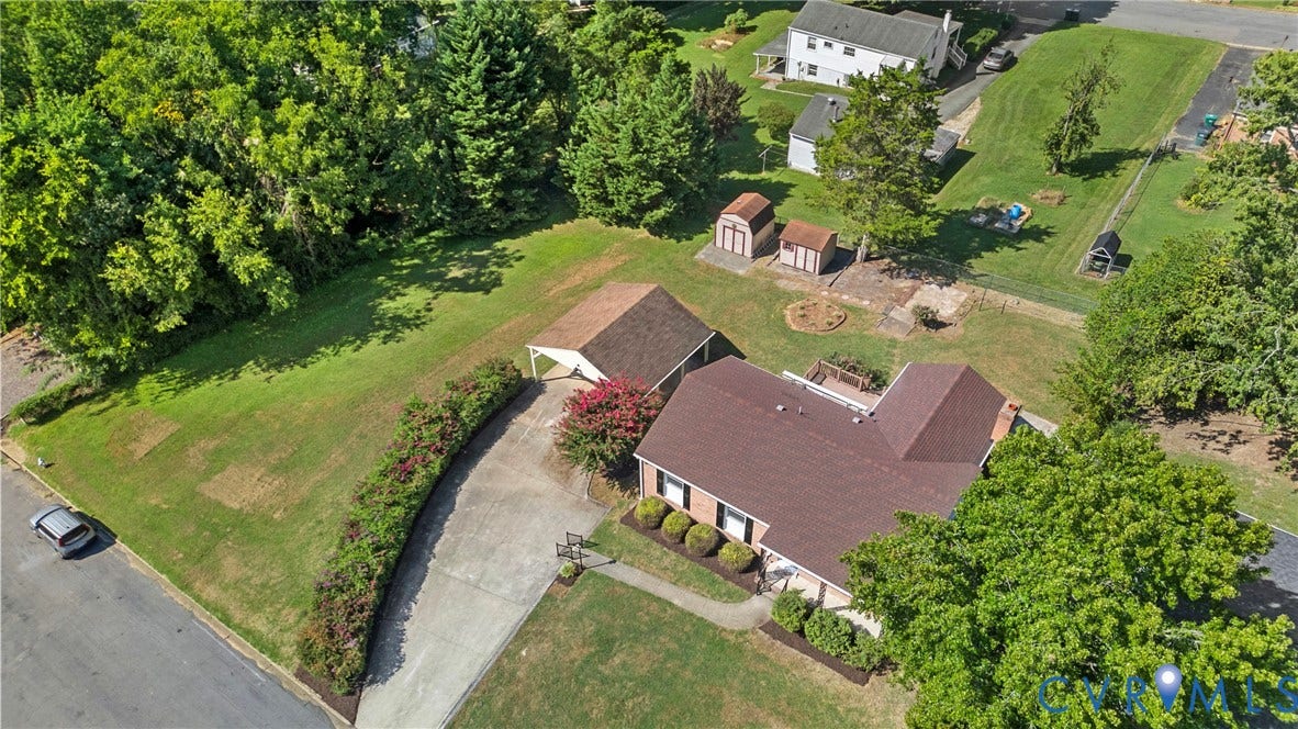 7402 Edgewood Avenue, Richmond, VA 23227 Expansive property featuring a detached carport, two storage sheds, and a paved driveway