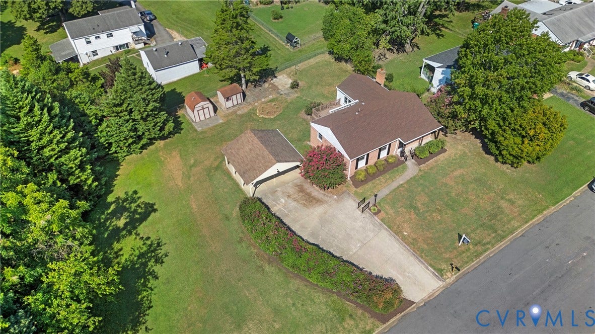 7402 Edgewood Avenue, Richmond, VA 23227 Single-story residence with a brown shingle roof, attached garage, and a concrete driveway