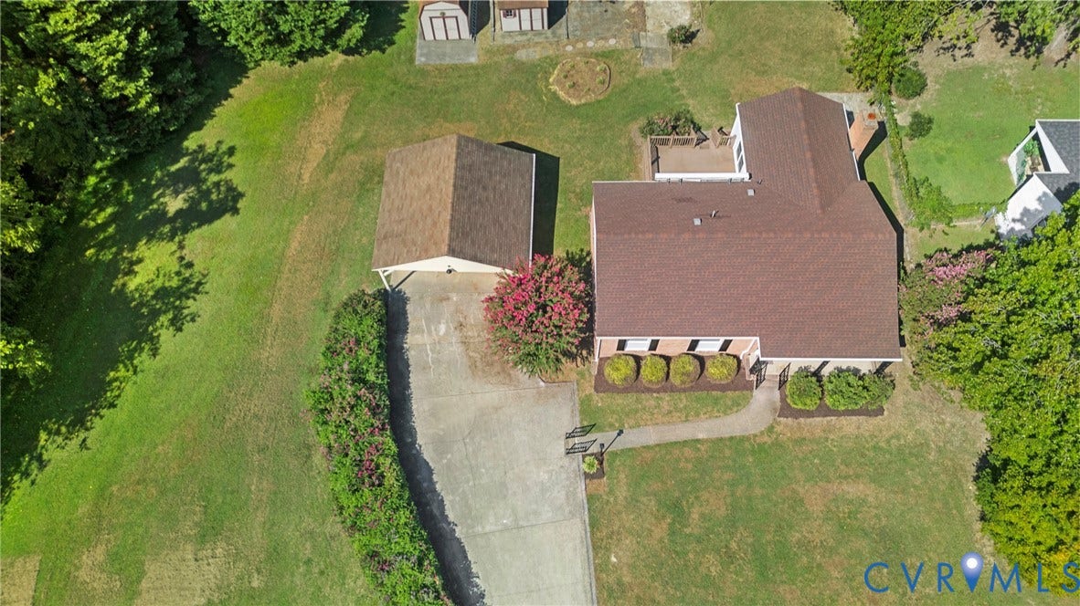 7402 Edgewood Avenue, Richmond, VA 23227 Expansive lot featuring a main residence with a large roof, a detached garage, a concrete driveway, and mature landscaping