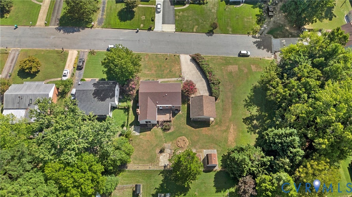 7402 Edgewood Avenue, Richmond, VA 23227 Expansive lot featuring mature trees, a private driveway, and a detached structure