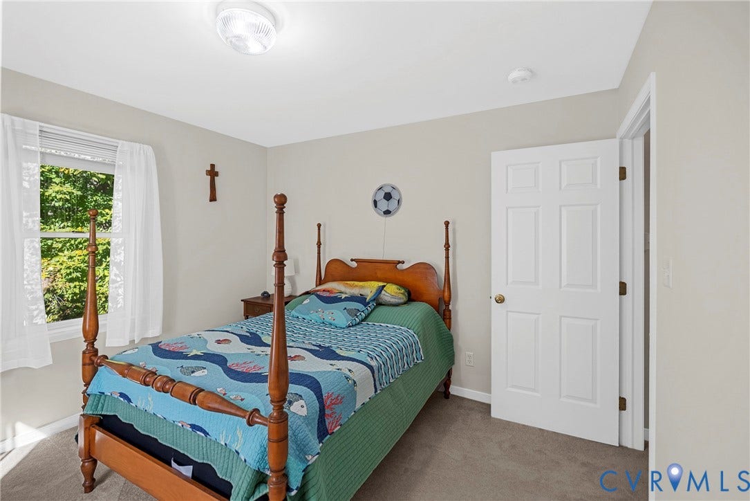 12082 Victoria Hills Road, Rockville, VA 23146 Neutral-toned interior space featuring neutral wall paint, wall-to-wall carpeting, a multi-pane window, and a white six-panel door with brass-finish hardware