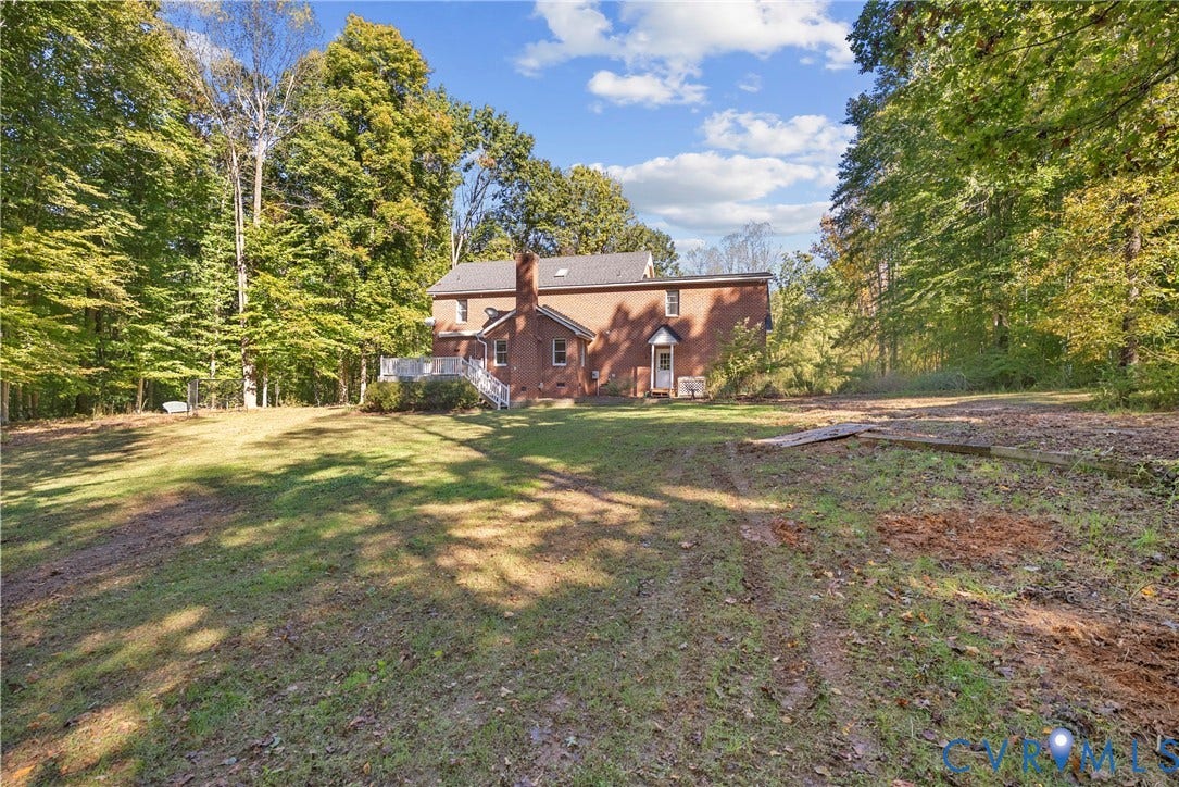 12082 Victoria Hills Road, Rockville, VA 23146 Brick exterior residence featuring a rear elevated deck and surrounding wooded acreage