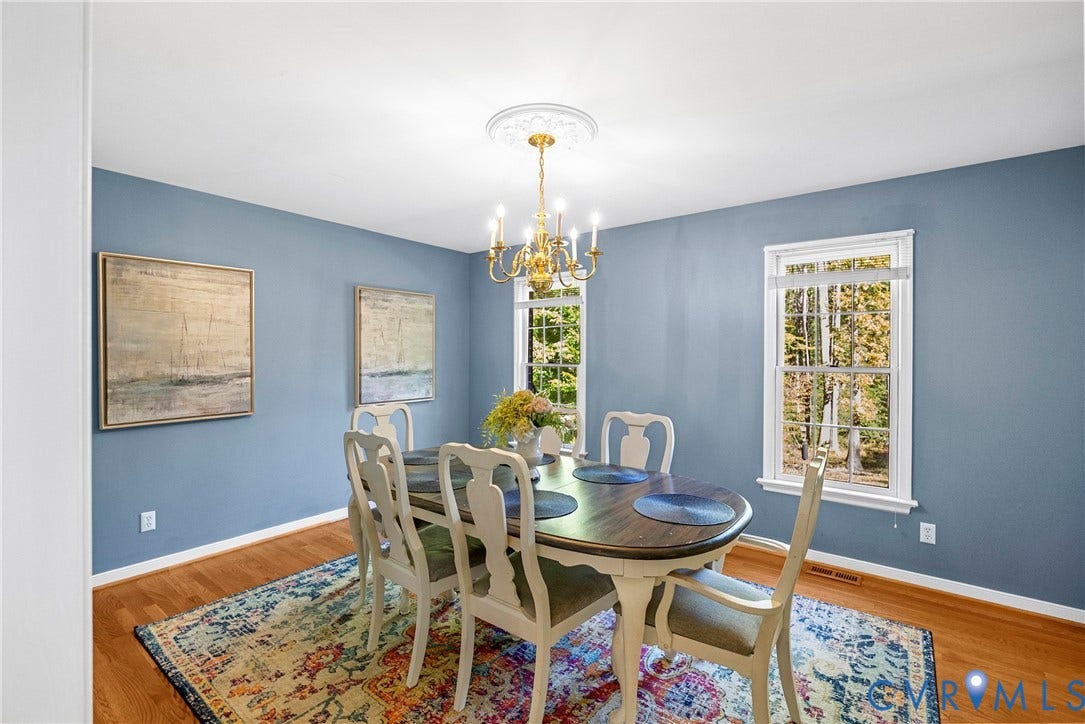 12082 Victoria Hills Road, Rockville, VA 23146 Dining area featuring wood-finish flooring, two double-hung windows, and a decorative ceiling medallion with a classic multi-arm chandelier