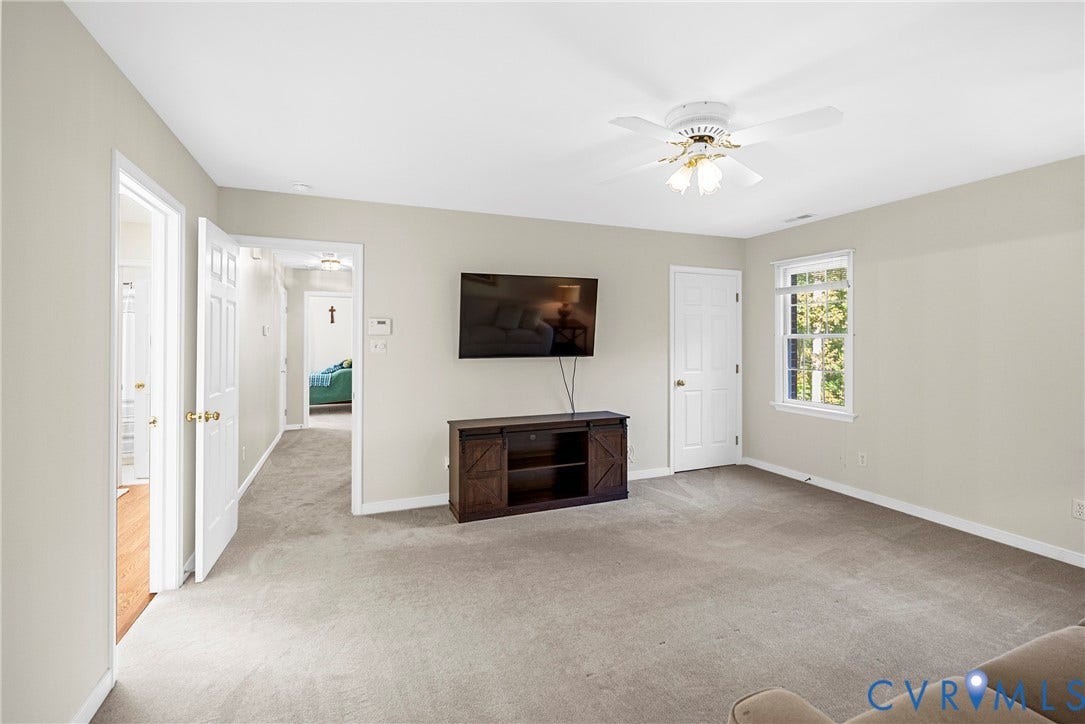 12082 Victoria Hills Road, Rockville, VA 23146 Neutral-toned interior featuring wall-to-wall carpeting, a multi-blade ceiling fan with integrated light fixture, and a single-hung window