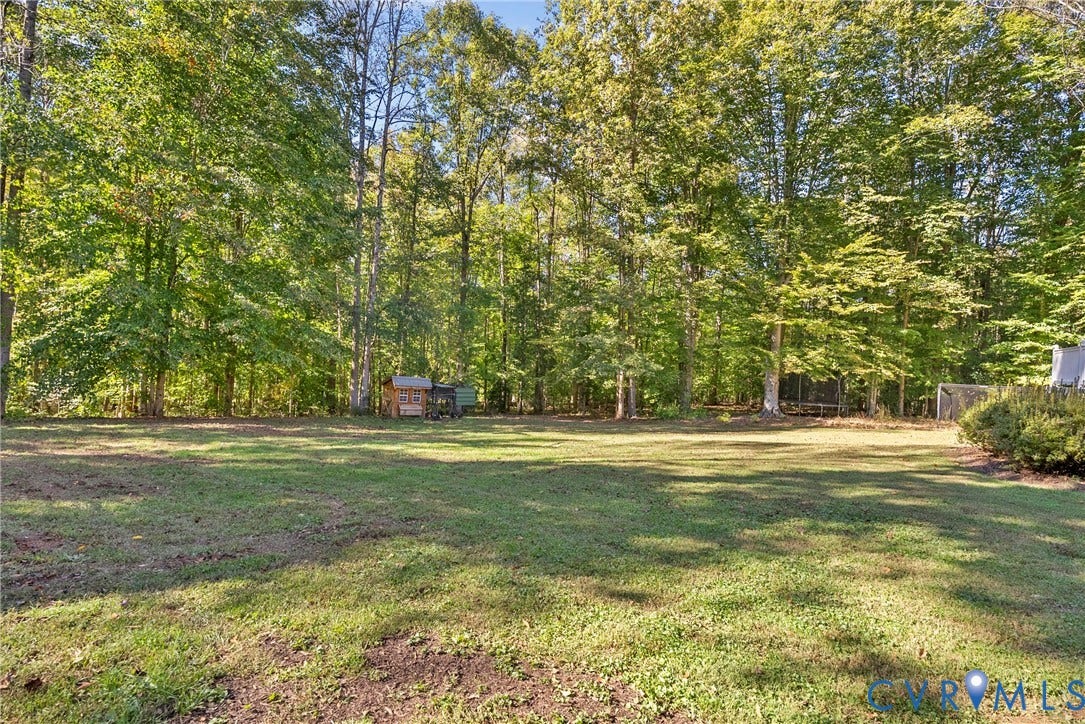 12082 Victoria Hills Road, Rockville, VA 23146 Expansive rear grounds featuring a grass lawn, mature trees, and natural woodland border
