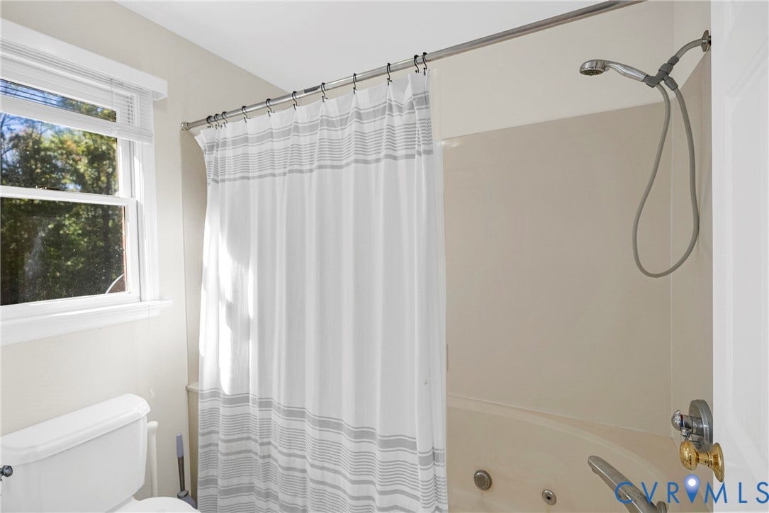 12082 Victoria Hills Road, Rockville, VA 23146 Bathroom featuring a jetted tub, a wall-mounted shower head, and a double-hung window