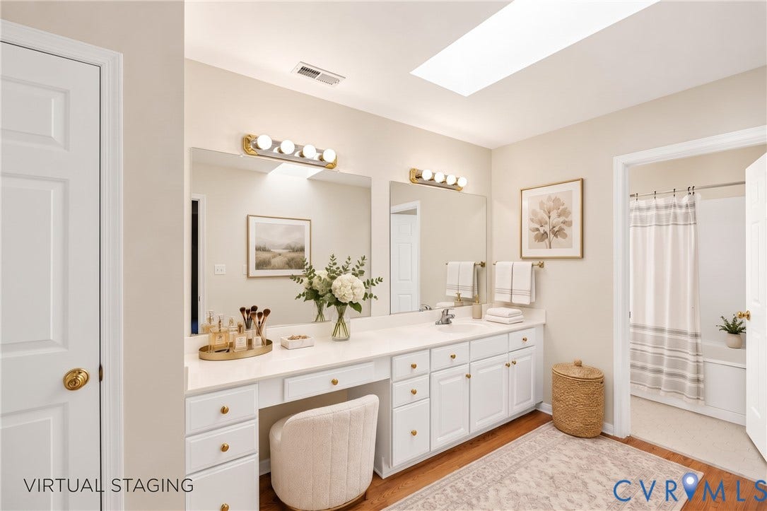 12082 Victoria Hills Road, Rockville, VA 23146 Double vanity with an integrated countertop, skylight, white shaker-style cabinetry, and polished hardware