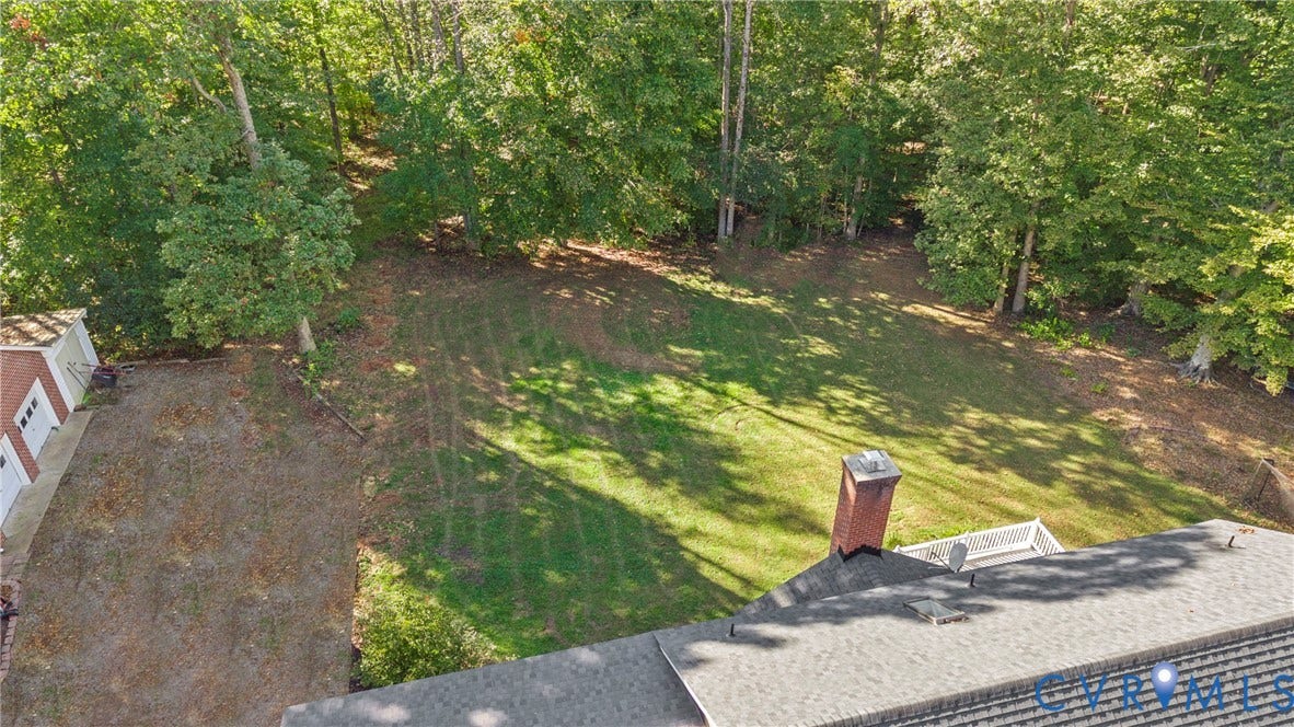 12082 Victoria Hills Road, Rockville, VA 23146 Expansive rear yard featuring mature trees, a brick chimney, an elevated deck, and a detached structure