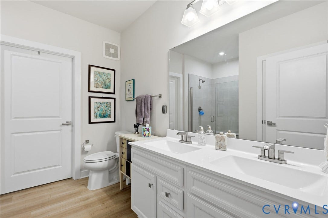 15801 Hallowell Ridge, #304, Moseley, VA 23120 Dual vanity with integrated sinks, brushed nickel fixtures, and a frameless mirror