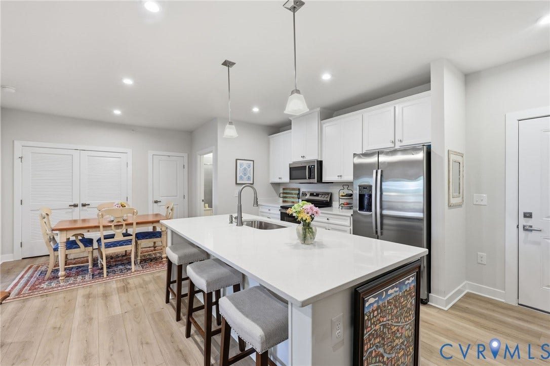 15801 Hallowell Ridge, #304, Moseley, VA 23120 Open-concept living area with wood-finish flooring, recessed lighting, and white cabinetry
