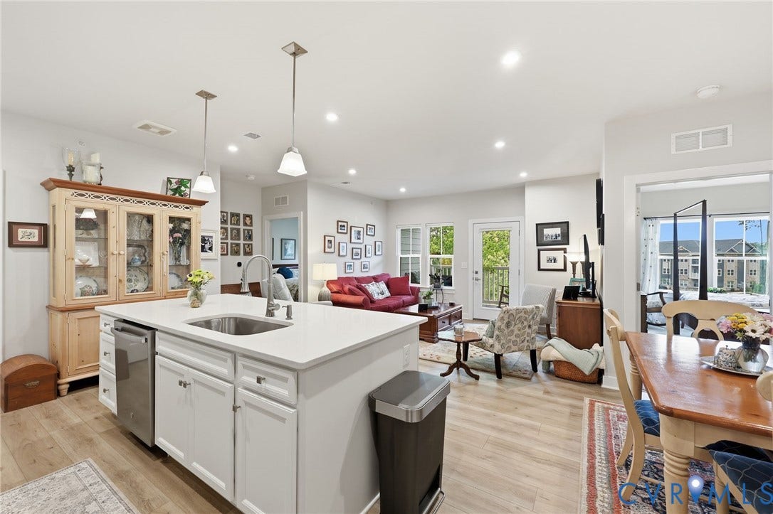 15801 Hallowell Ridge, #304, Moseley, VA 23120 Kitchen island with integrated sink and stainless steel dishwasher, wood-finish flooring, recessed lighting, and a white door leading to an outdoor balcony