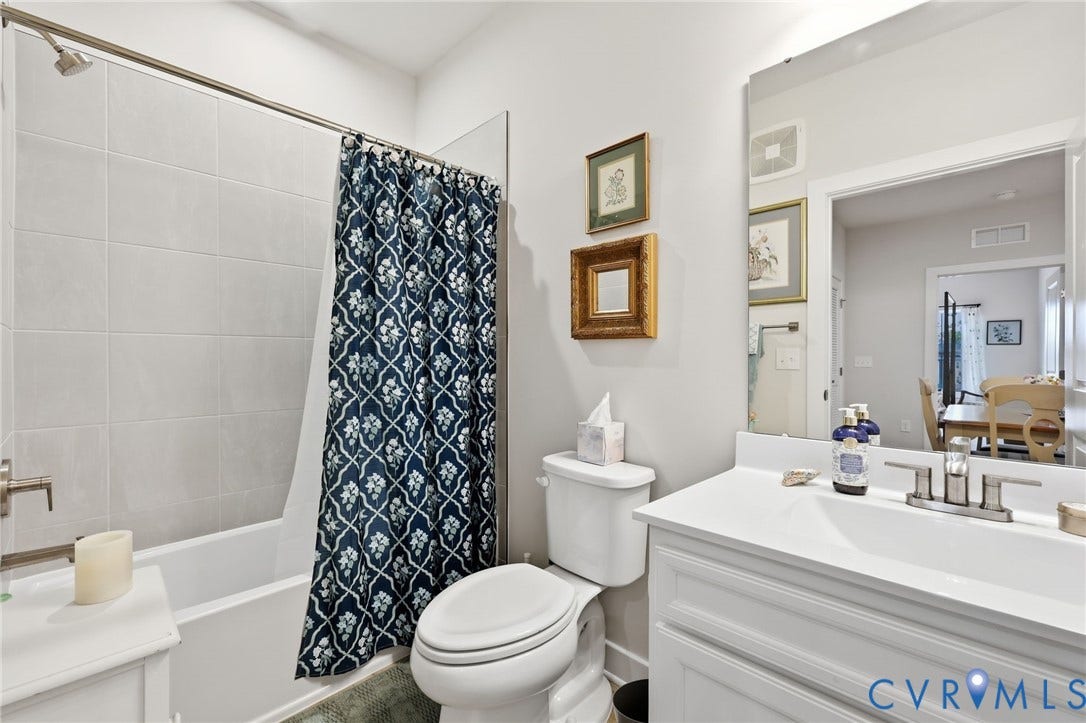 15801 Hallowell Ridge, #304, Moseley, VA 23120 White vanity with a single basin sink, brushed nickel faucet, and a large wall-mounted mirror