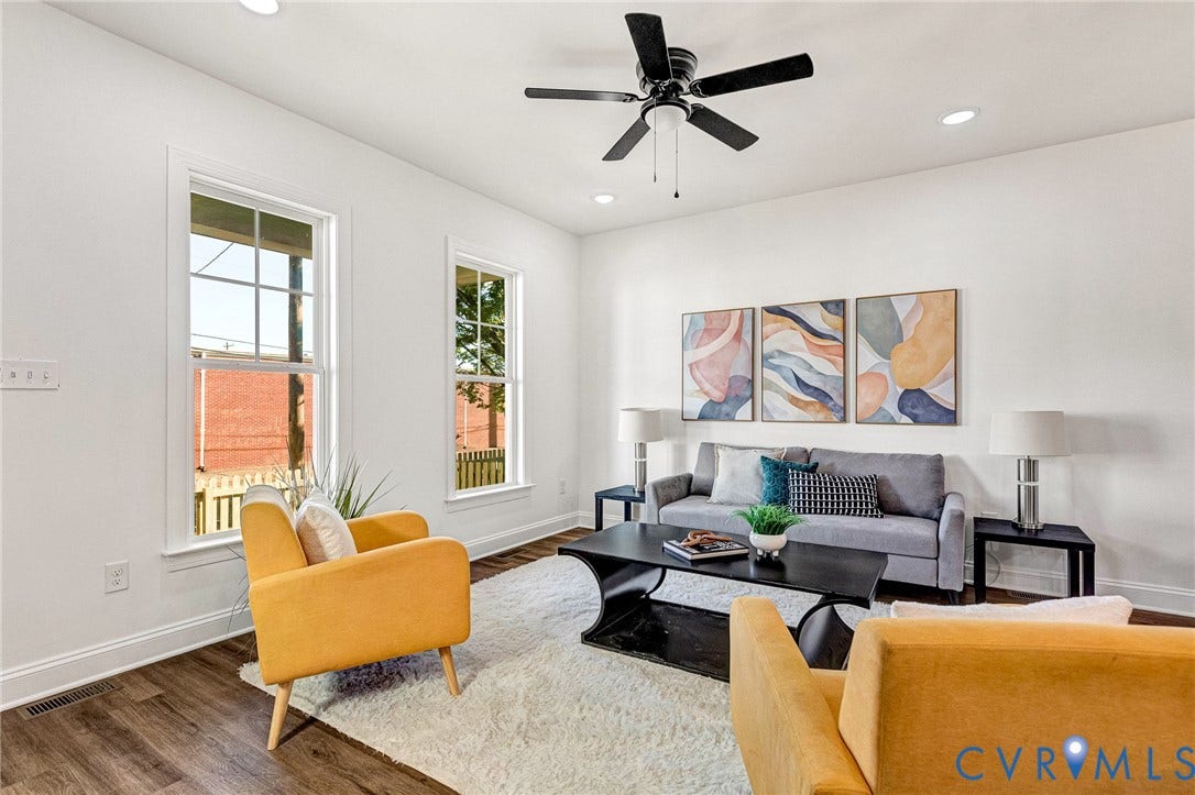 Recessed lighting, wood-finish flooring, white walls, multiple windows, and a ceiling fan