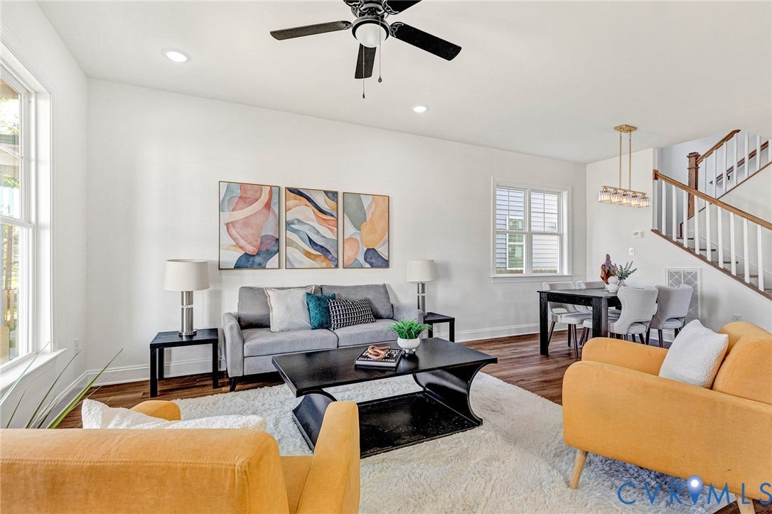 Open-concept living space featuring wood-finish flooring, recessed lighting, and a ceiling fan