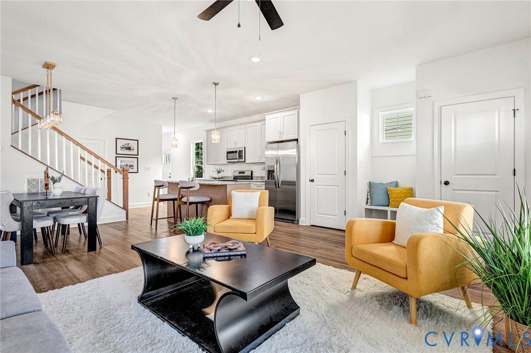 Open-concept living space featuring wood-finish flooring, recessed lighting, and a contemporary ceiling fan