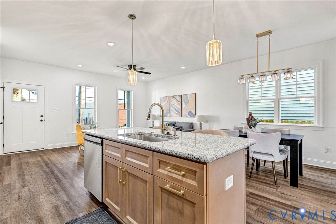 Open-concept living space featuring wood-finish flooring, recessed lighting, and white walls