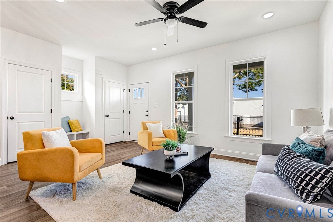 Recessed lighting, wood-finish flooring, ceiling fan, white paneled doors, and multiple windows