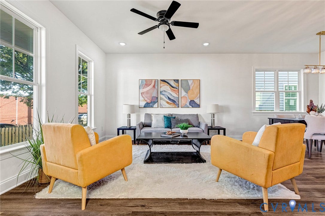 Spacious living area featuring wood-finish flooring, recessed lighting, and a ceiling fan