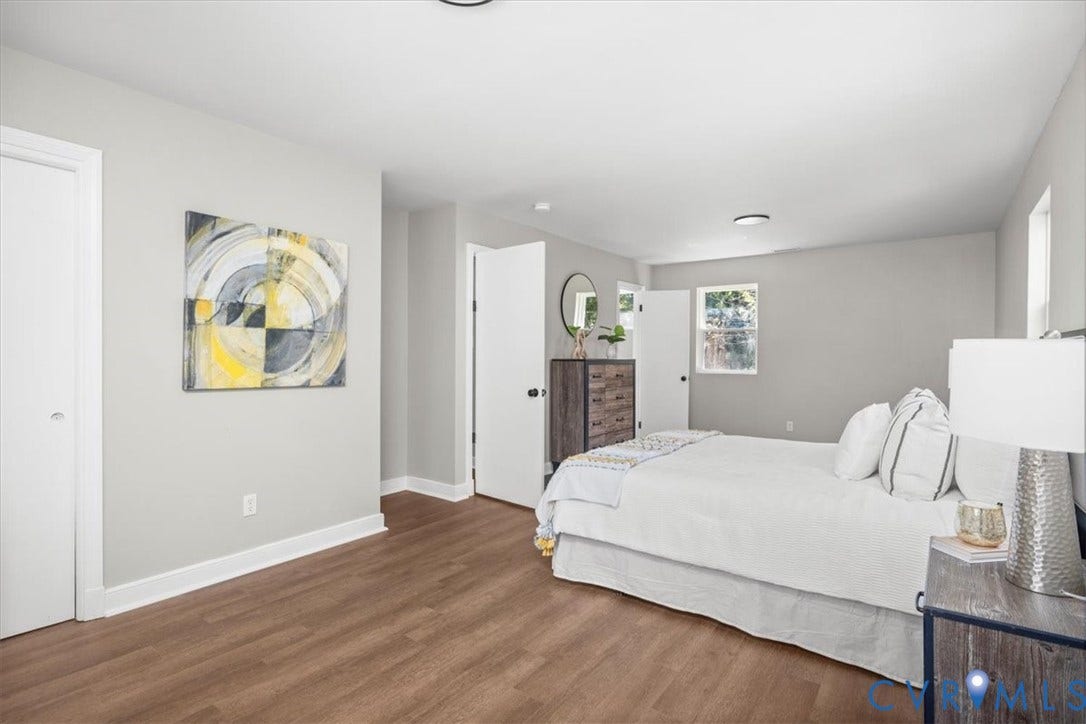 Wood-finish flooring, light gray wall paint, and white trim