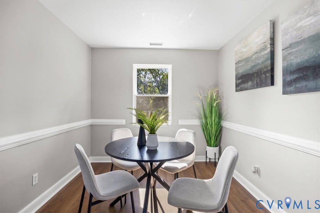 Hardwood-finish flooring, single window, chair rail molding, and light-toned walls