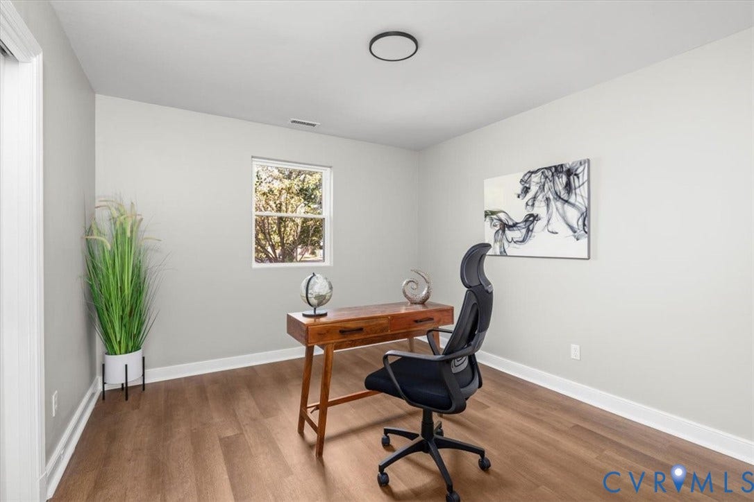 Wood-finish flooring, single pane window, ceiling-mounted light fixture, white trim, and light gray wall paint