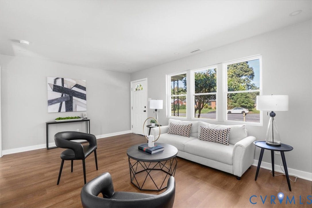 Wood-finish flooring throughout, light gray wall finishes, bright white trim, recessed lighting, and multiple large windows