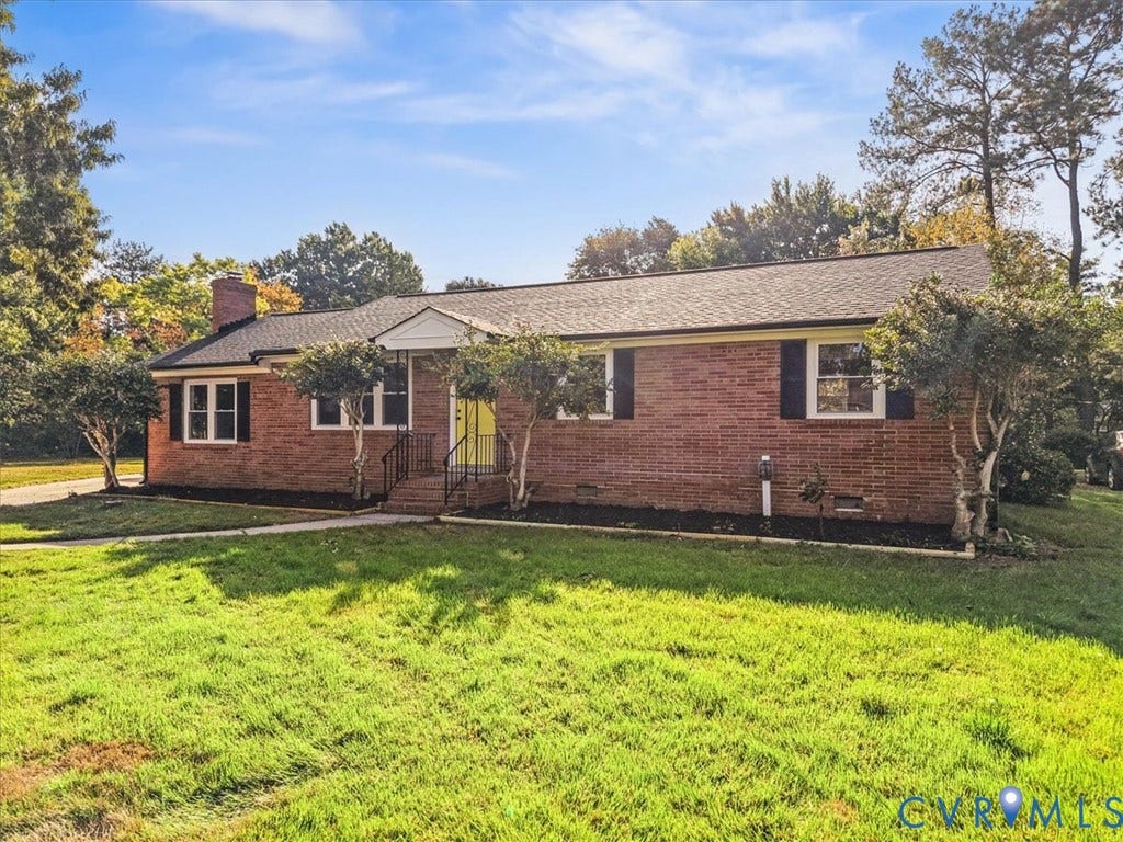 Brick exterior with black shutters and a black shingle roof