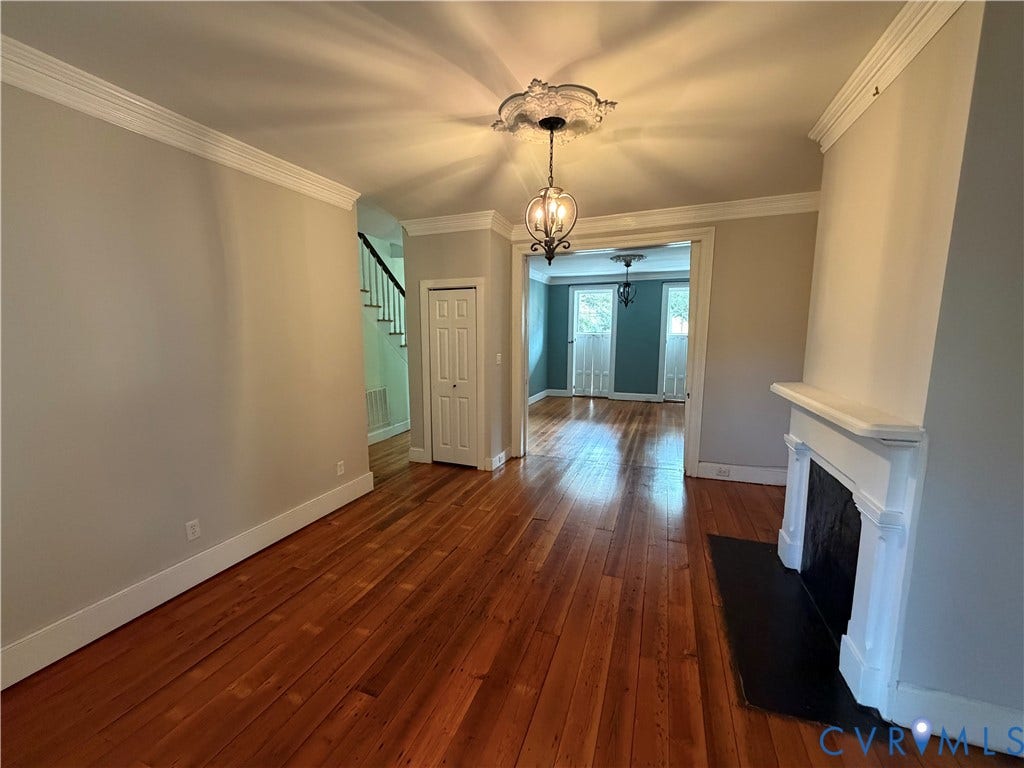 315 Grove Avenue, Petersburg, VA 23803 Hardwood flooring, decorative crown molding, traditional fireplace with mantel, ceiling medallion, and a chandelier