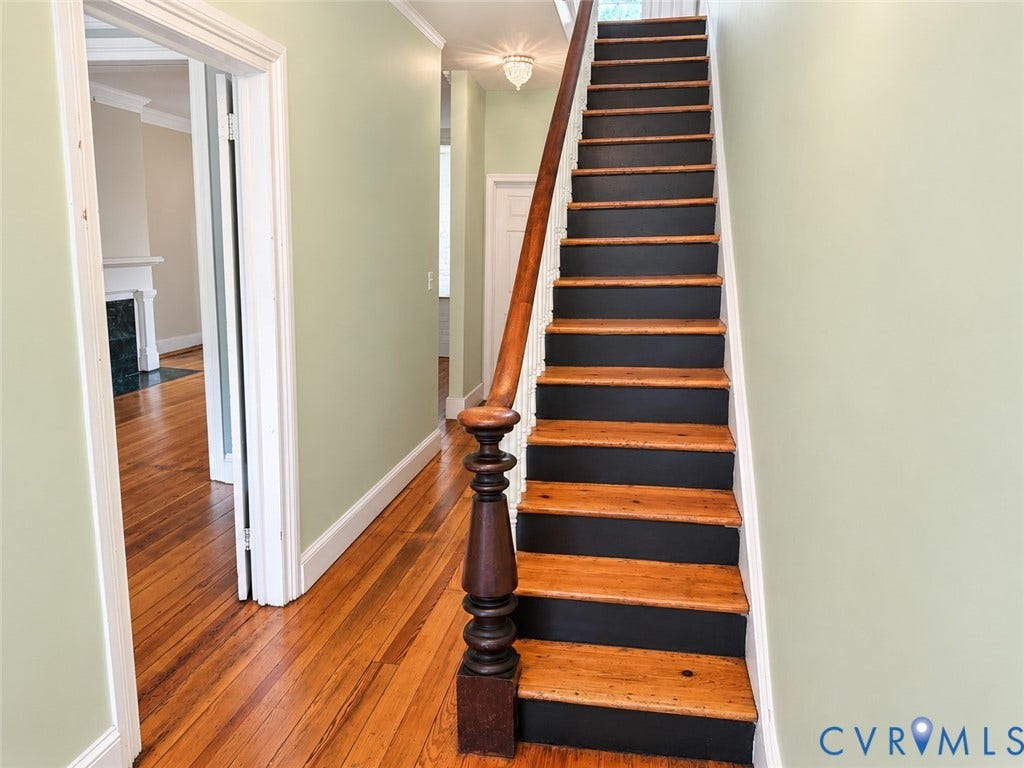 315 Grove Avenue, Petersburg, VA 23803 Hardwood flooring throughout, a classic wooden staircase with painted risers, and a prominent dark wood newel post