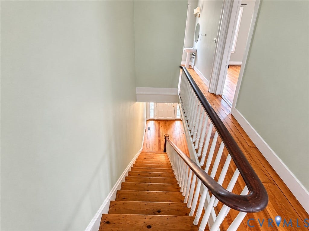 315 Grove Avenue, Petersburg, VA 23803 Hardwood flooring throughout, classic wooden staircase with white balusters, and a solid wood handrail