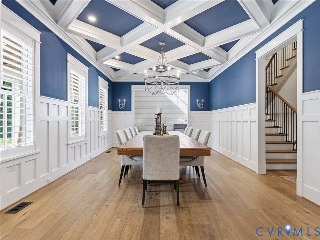 Coffered ceiling with recessed lighting, wood-finish flooring, wainscoting, and a chandelier