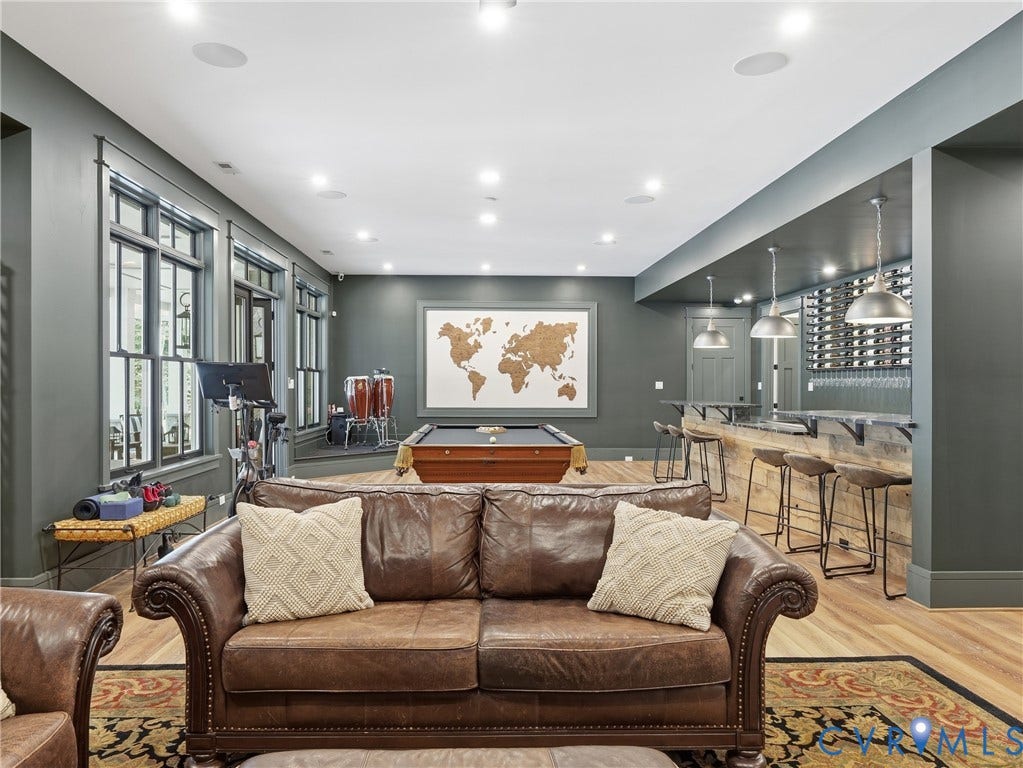 Recreation room featuring wood-finish flooring, a built-in bar with pendant lighting, a pool table, and recessed ceiling lights