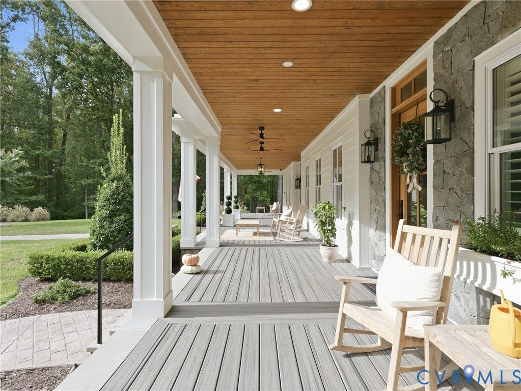Expansive covered porch with wood-finish ceiling, recessed lighting, and grey plank flooring