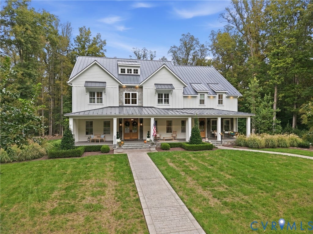 Two-story exterior with white siding and stone accents