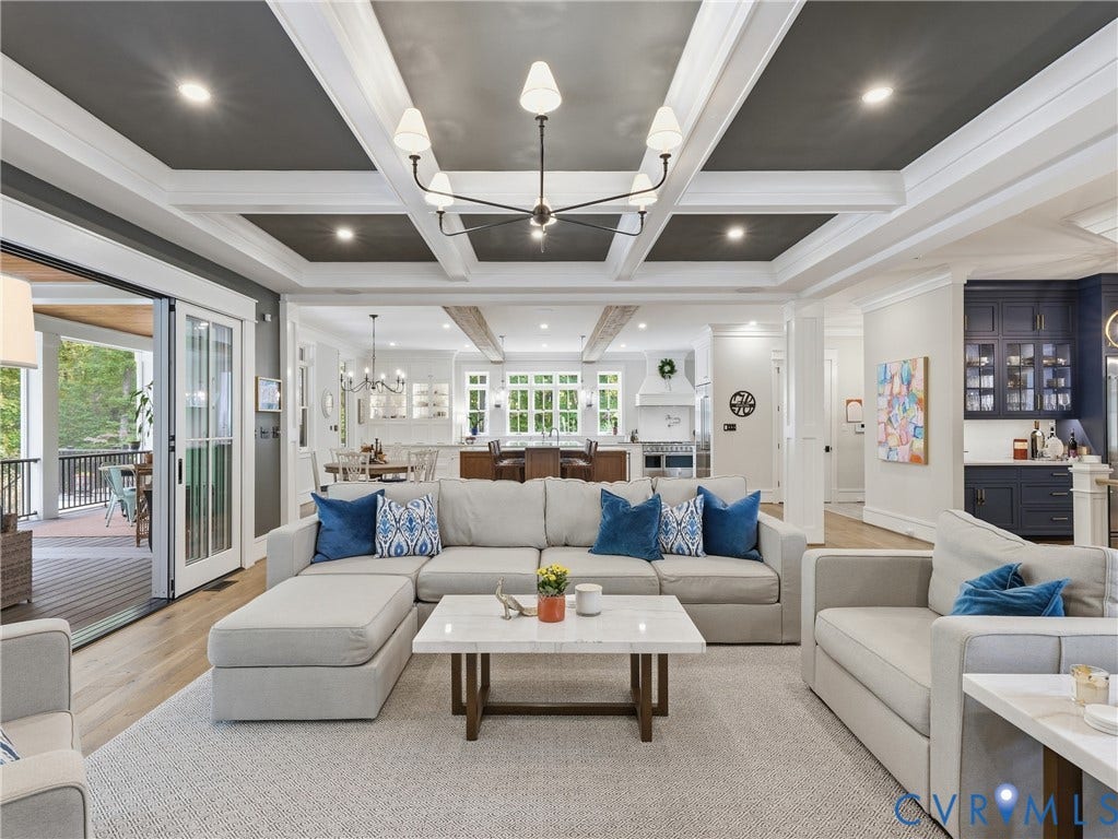 Coffered ceiling with recessed lighting and a contemporary chandelier