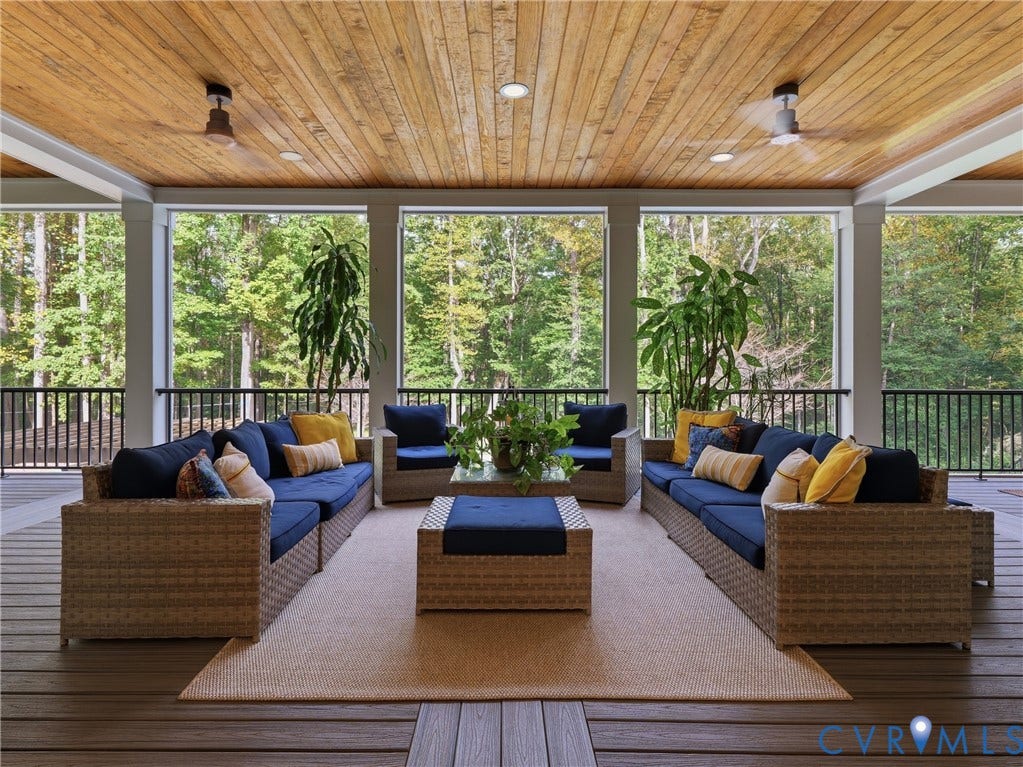 Expansive covered porch featuring a wood plank ceiling, recessed lighting, and ceiling fans