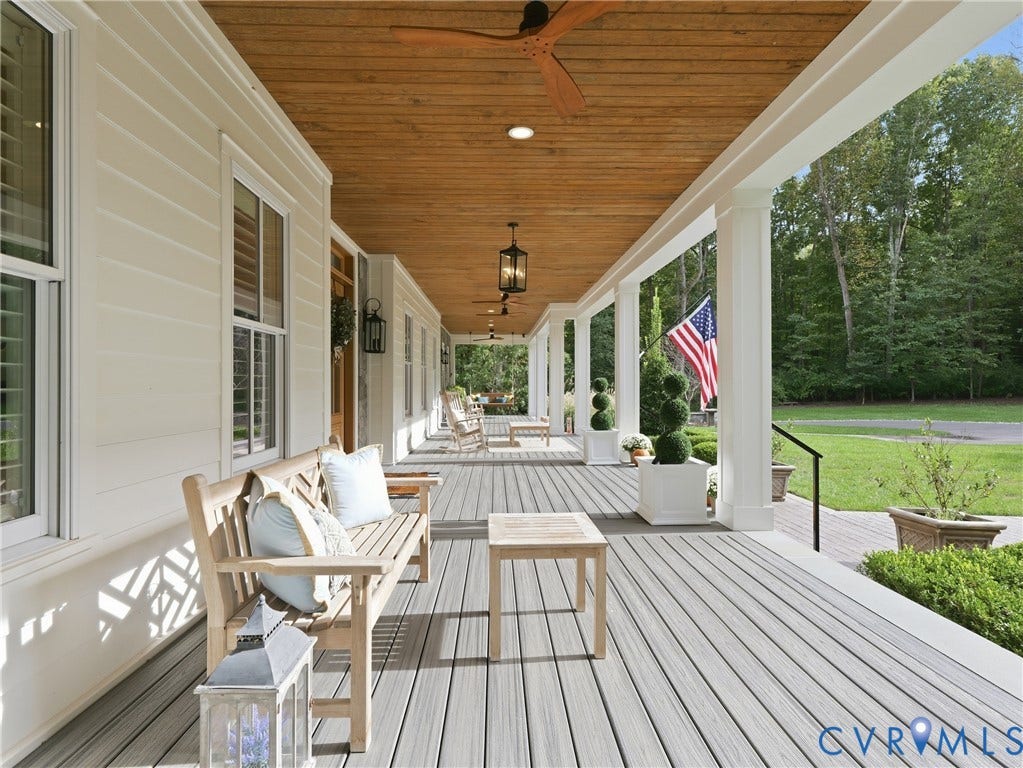 Expansive covered porch featuring wood-finish ceiling, multiple ceiling fans, recessed lighting, and a composite deck