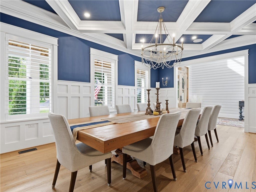 Coffered ceiling with recessed lighting, chandelier, and hardwood flooring