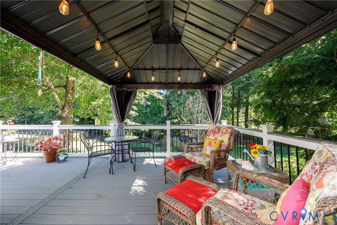 717 McCauliff Drive, Chesterfield, VA 23236 Expansive outdoor deck featuring a covered gazebo with string lighting, privacy drapes, and white railing with black spindles