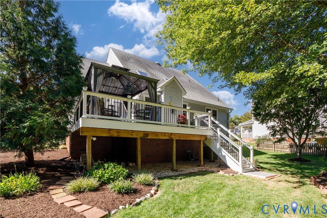 717 McCauliff Drive, Chesterfield, VA 23236 Expansive backyard featuring a manicured lawn, established landscaping, and a deck with gazebo
