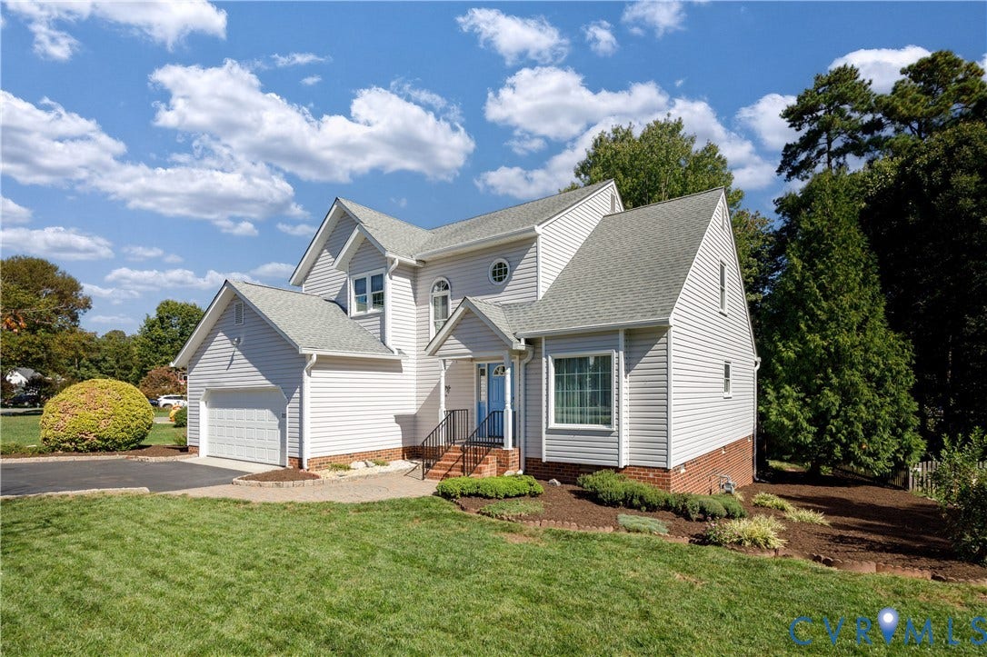 717 McCauliff Drive, Chesterfield, VA 23236 Siding exterior with an attached garage, and a landscaped front yard with mature trees