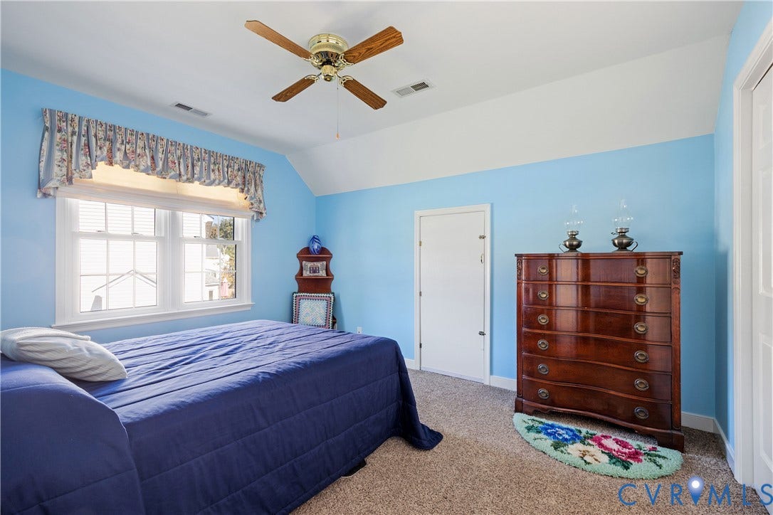 717 McCauliff Drive, Chesterfield, VA 23236 White double-hung window with white trim, wood-finish ceiling fan