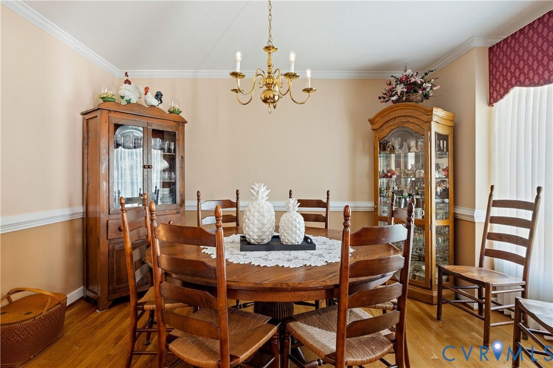717 McCauliff Drive, Chesterfield, VA 23236 Light wood-finish flooring with a gold-tone chandelier