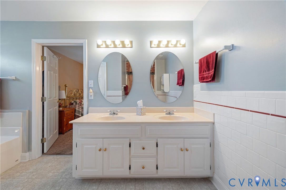 717 McCauliff Drive, Chesterfield, VA 23236 Dual vanity with white cabinetry and gold-tone hardware