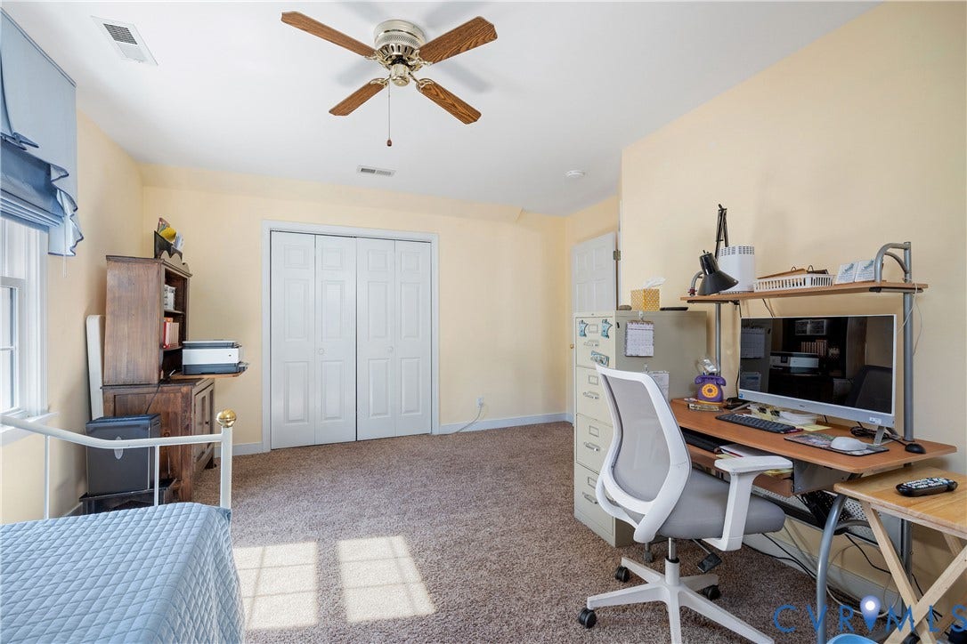 717 McCauliff Drive, Chesterfield, VA 23236 Carpeted flooring, a window with a blue roman shade, a ceiling fan with light, and white bi-fold closet doors