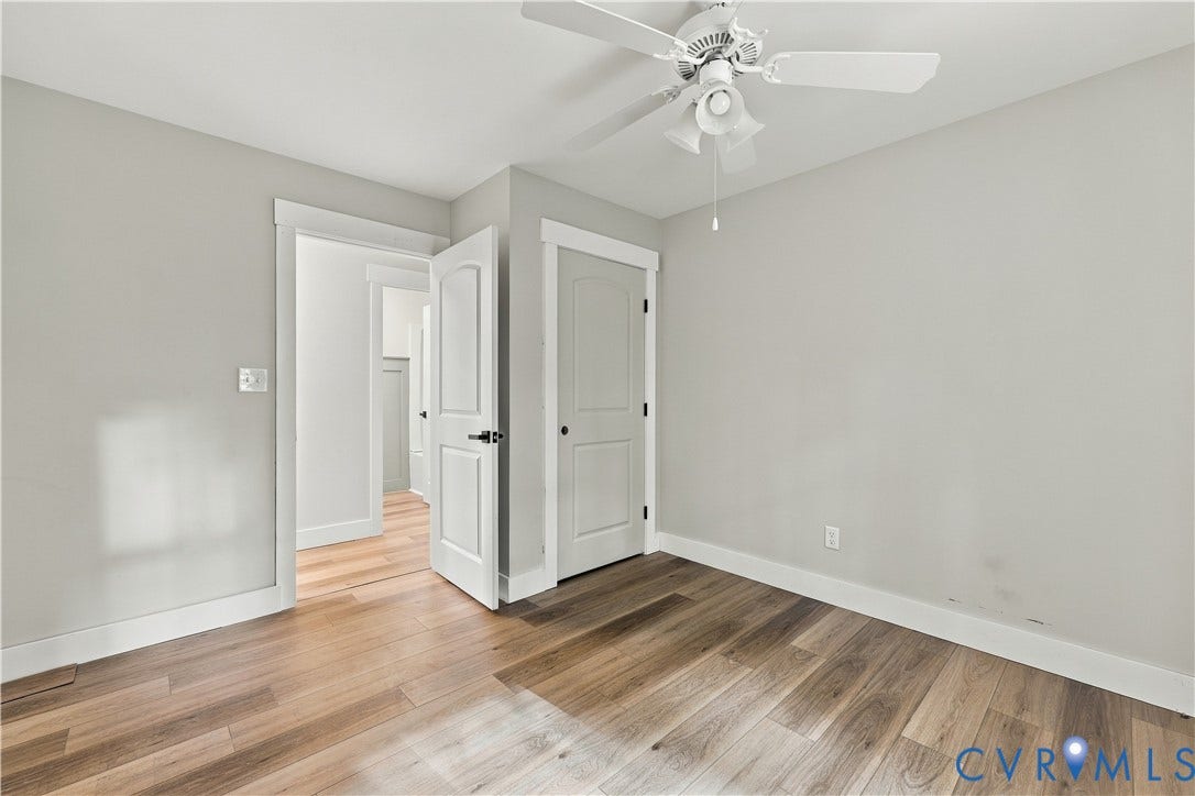 17 River Walk, Cumberland, VA 23027 Wood-finish flooring, white trim, light gray walls, white ceiling fan with integrated lighting, and white paneled doors