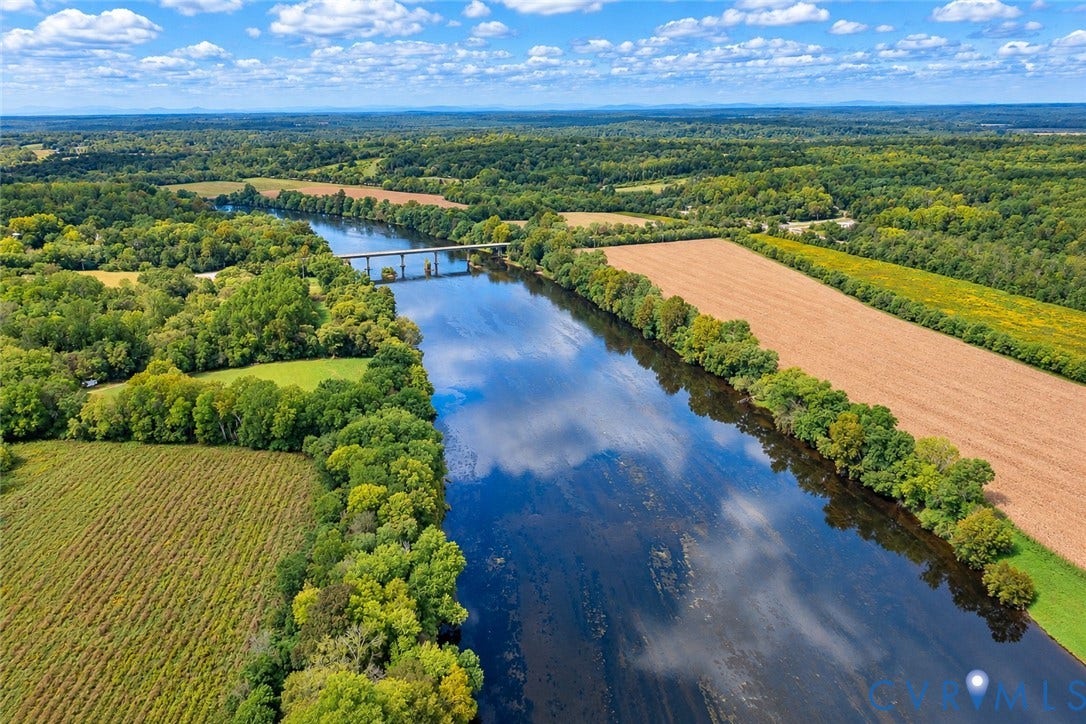 17 River Walk, Cumberland, VA 23027 Expansive river with a multi-span bridge, surrounded by lush green trees, cultivated fields, and open land